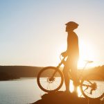 Silhouette of a man on mountain-bike during sunset.