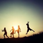 Children playing on summer sunset happy time