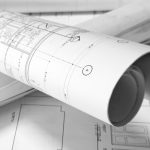 roled -up plans on the table